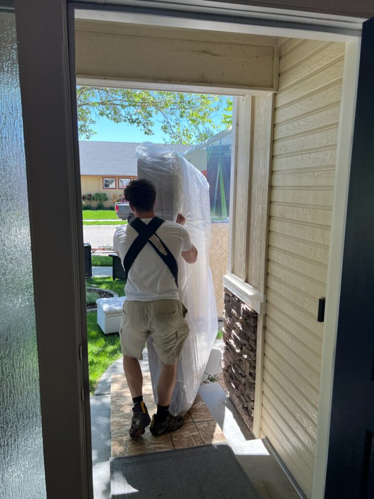 men carrying mattress