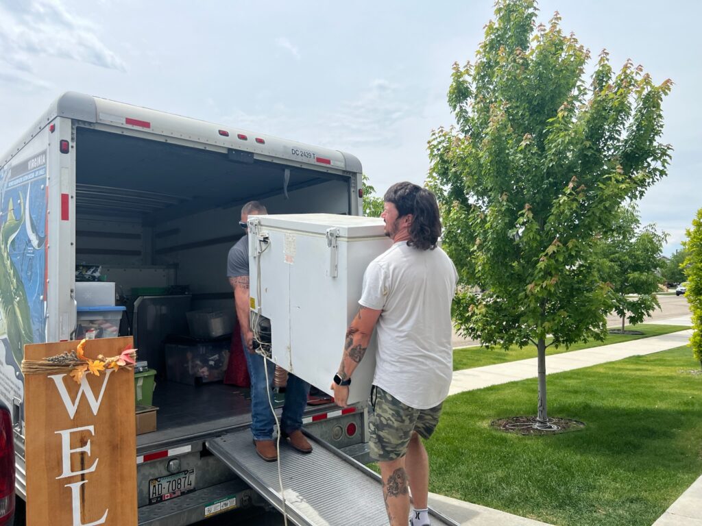 carrying a freezer onto a Uhaul truck