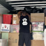 moving and stacking boxes in the back of a moving van